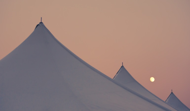 top of white tent beside the moon