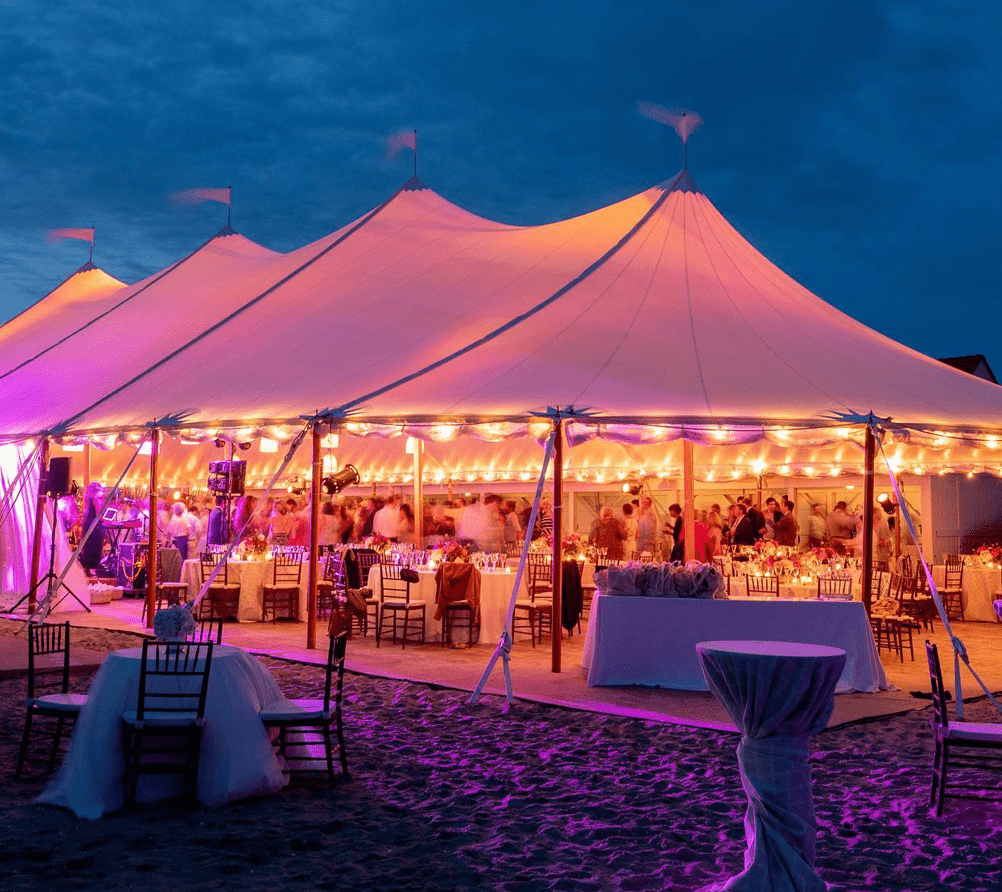 purple lighting on large white tent