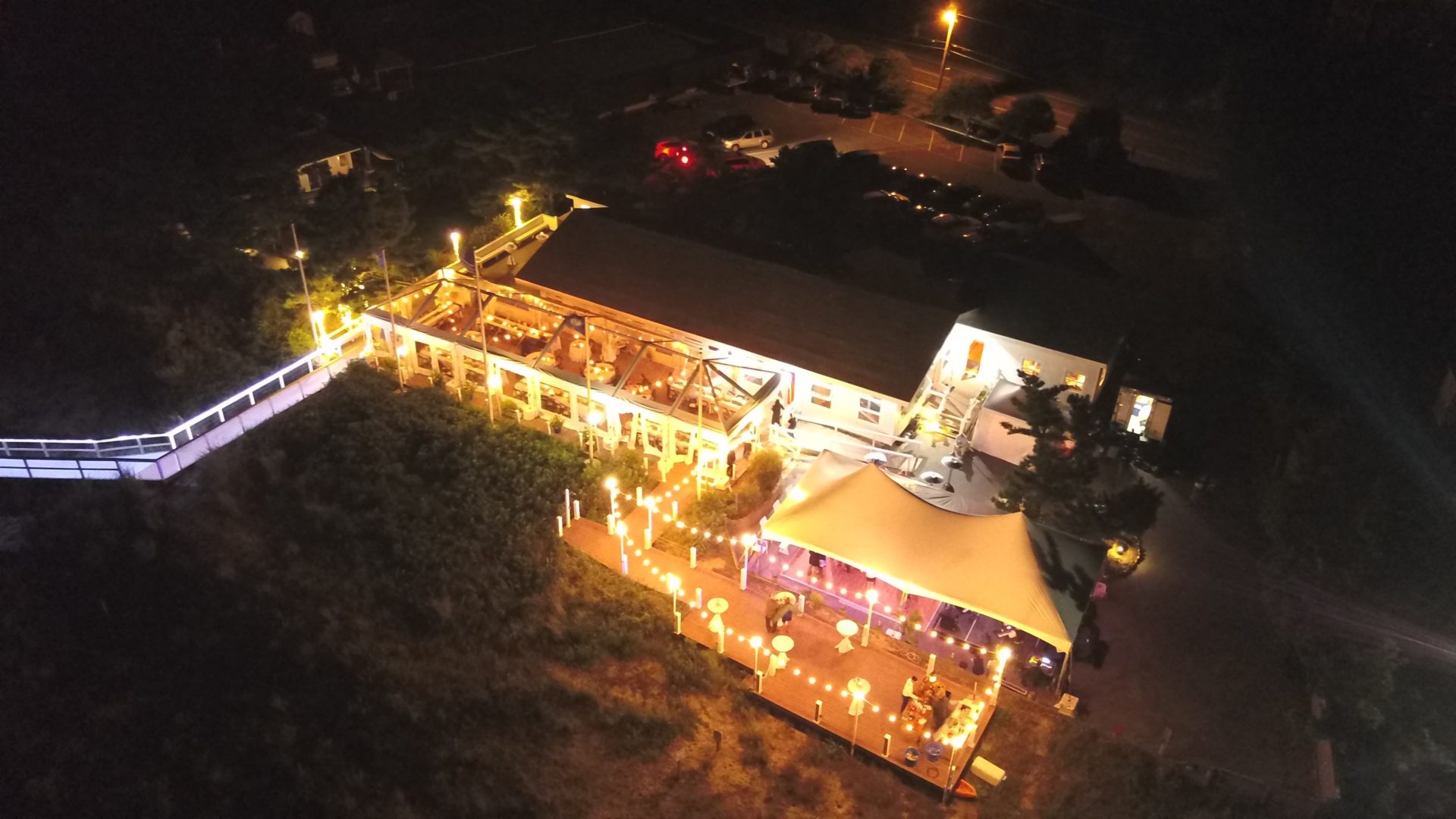 aerial view of white tent with string lights