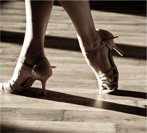 nude high heel shoes on a wood floor