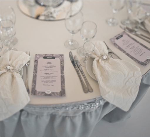 table setting with decorative napkins and menu