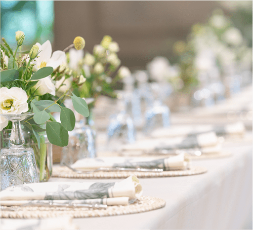 multiple table settings with white flower center piece