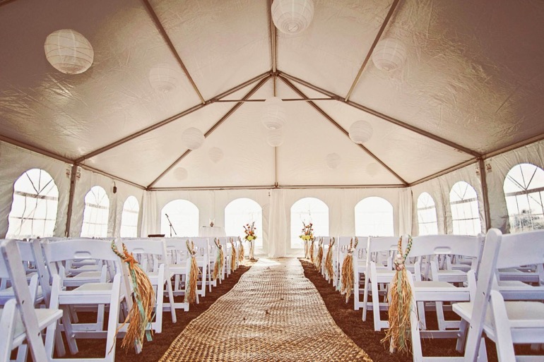 wedding reception tent with white chairs