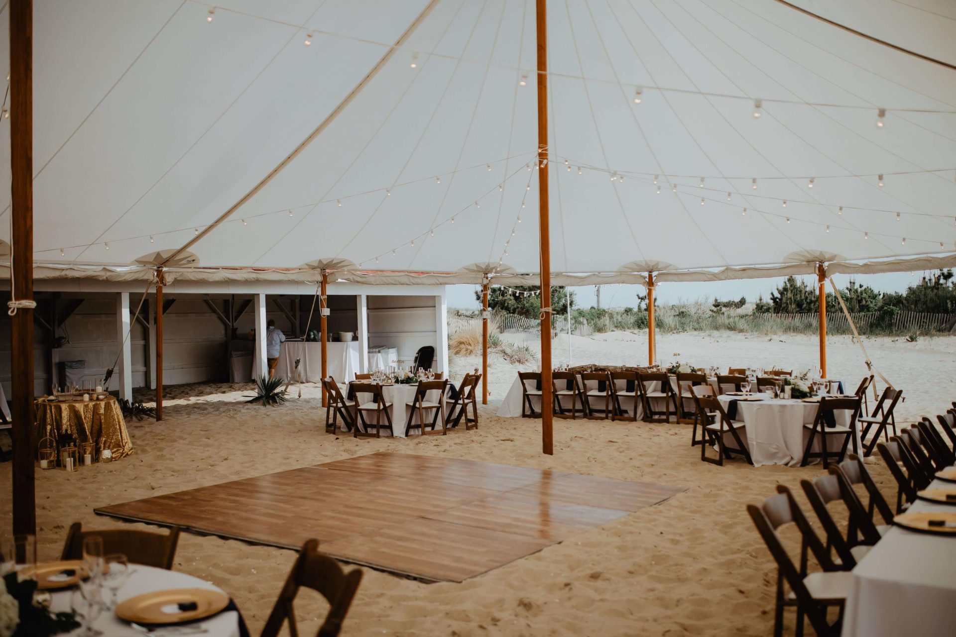 sail cloth tent in the sand with wood dance floor