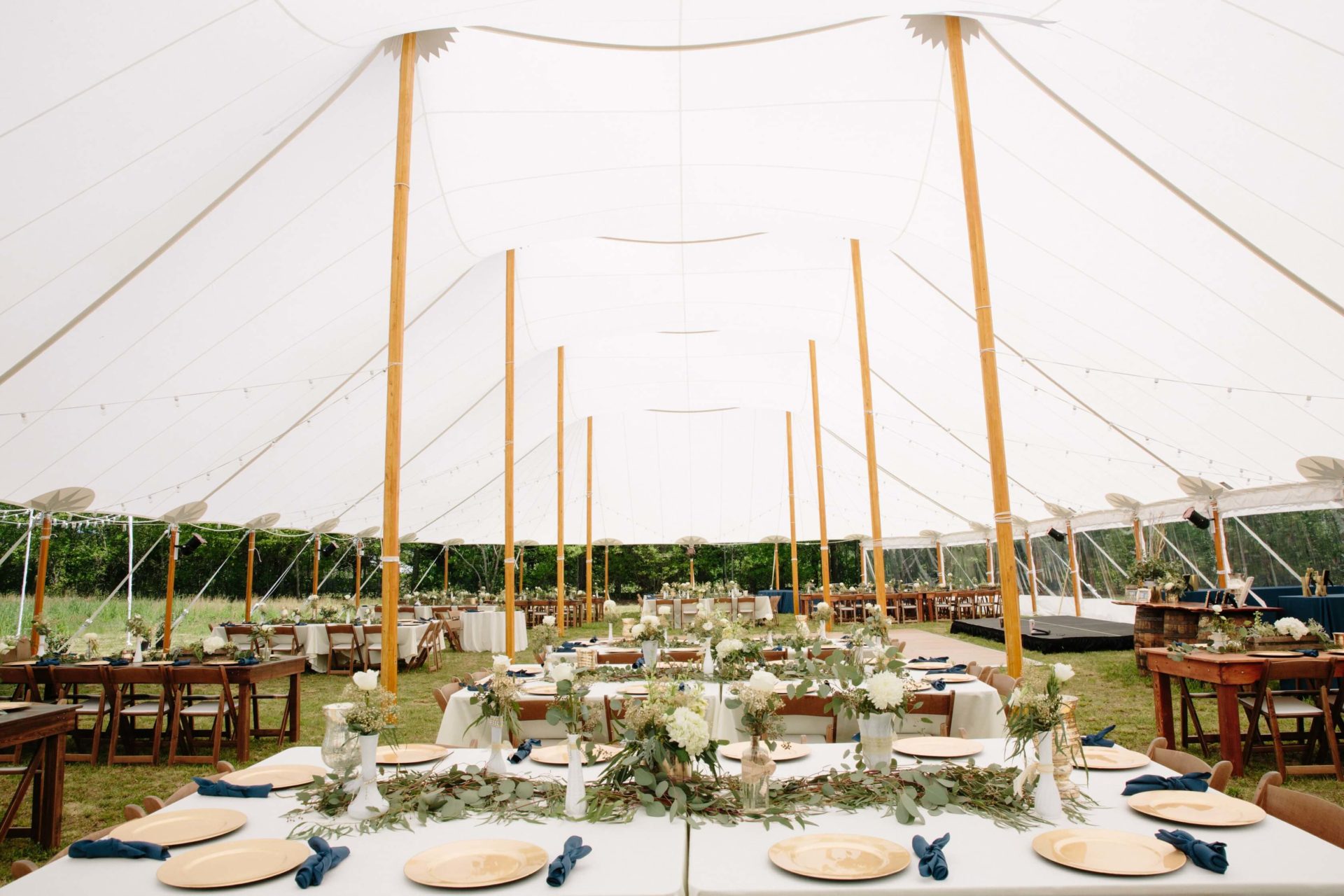 white sail cloth tent with tables set underneath
