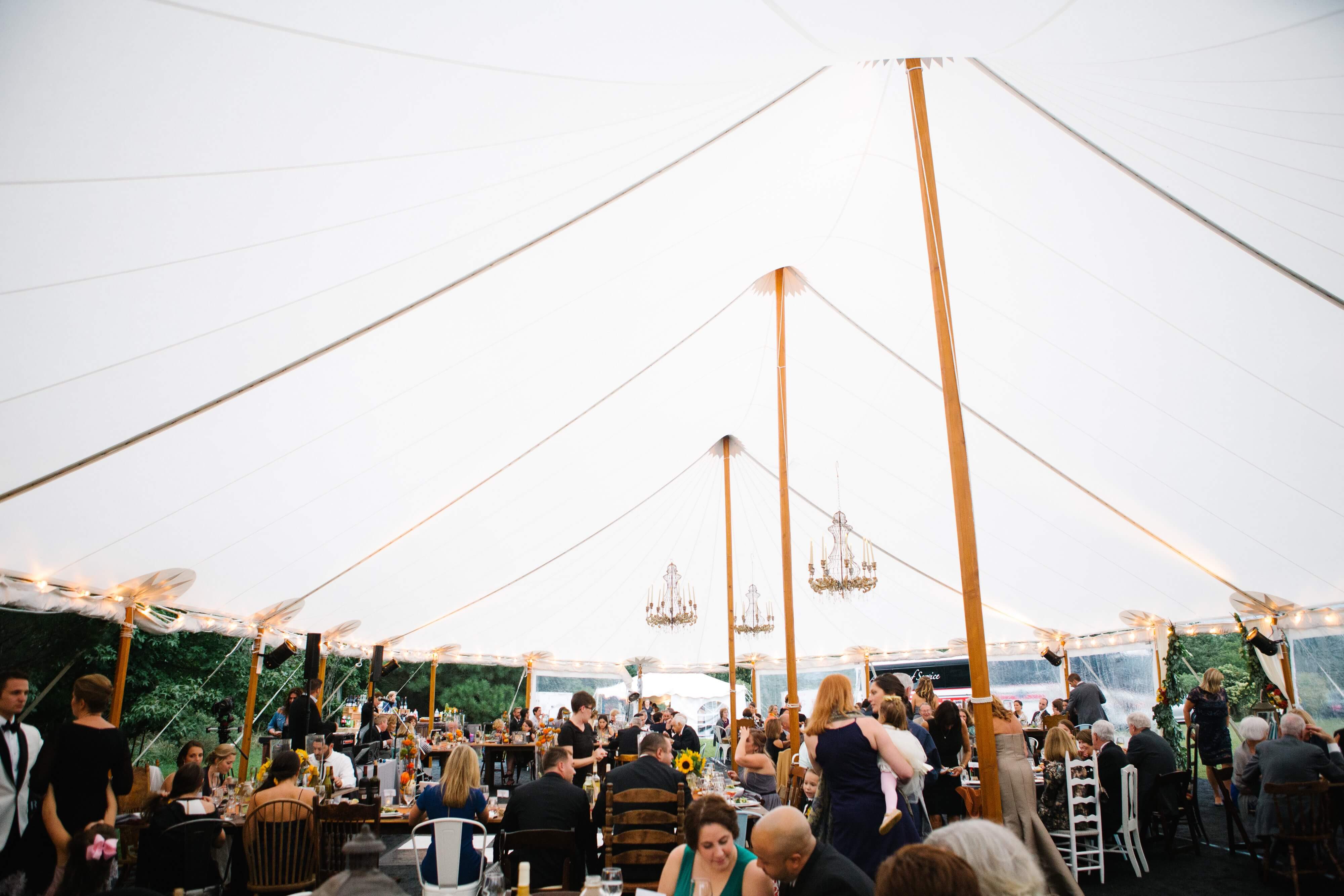white sail cloth tent with multiple chandeliers
