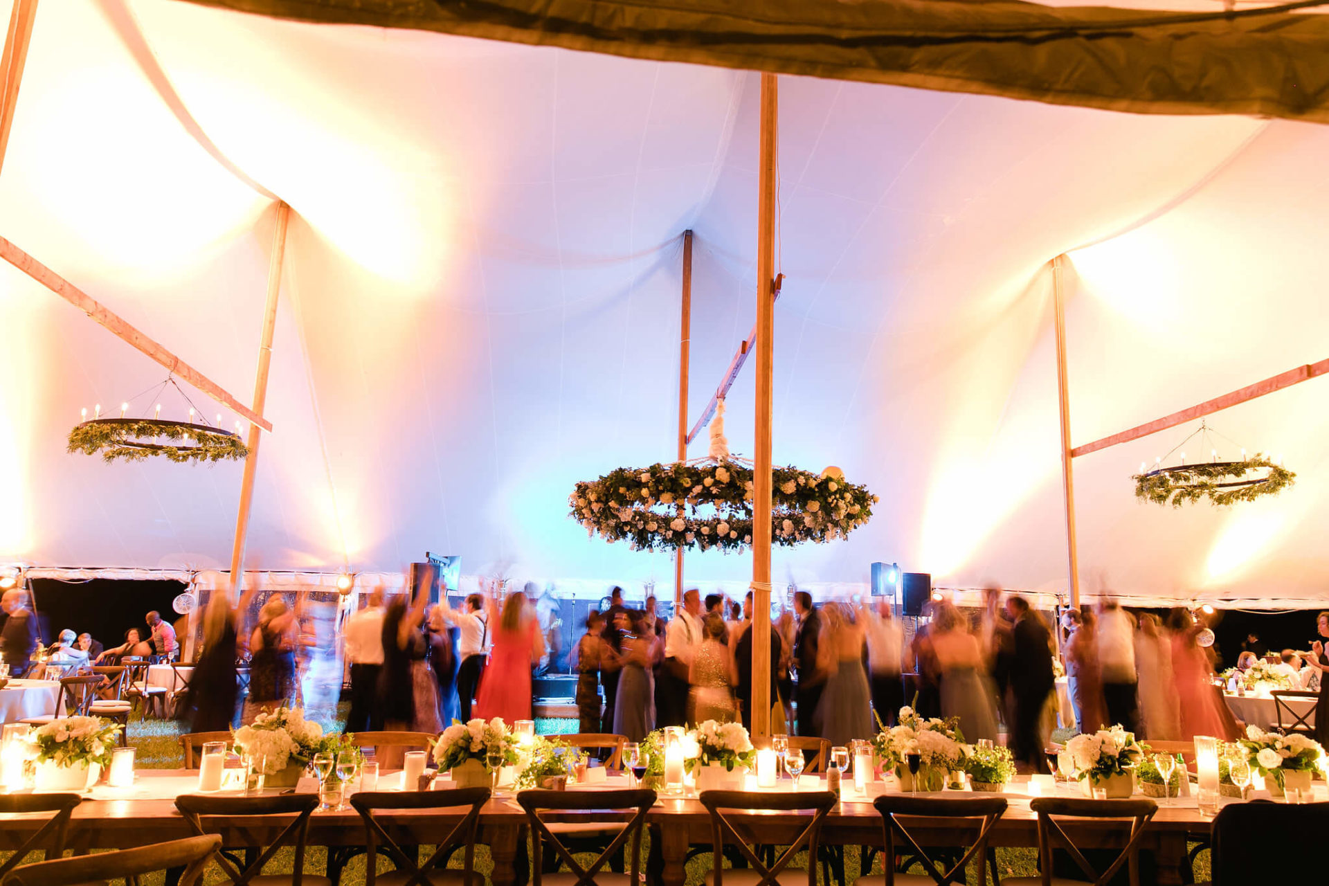 colorful uplighting inside white sail cloth tent