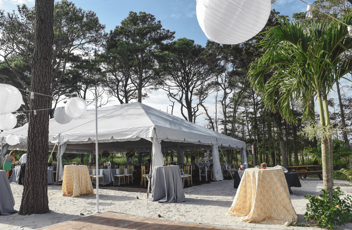large white tent surrounded by trees