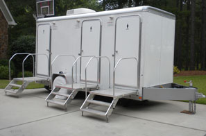 white restroom trailer with metal steps