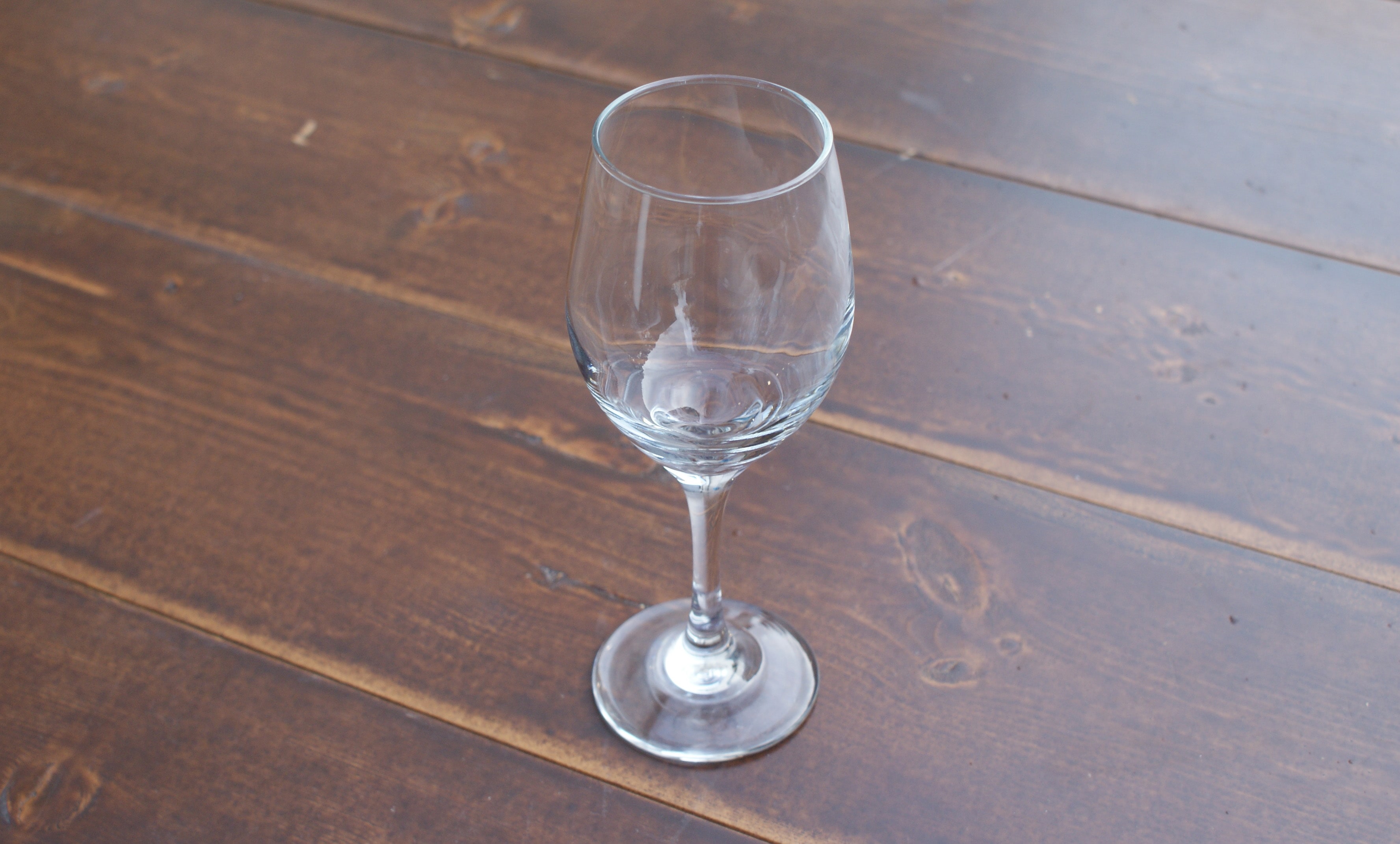 all purpose wine glass on a wood table