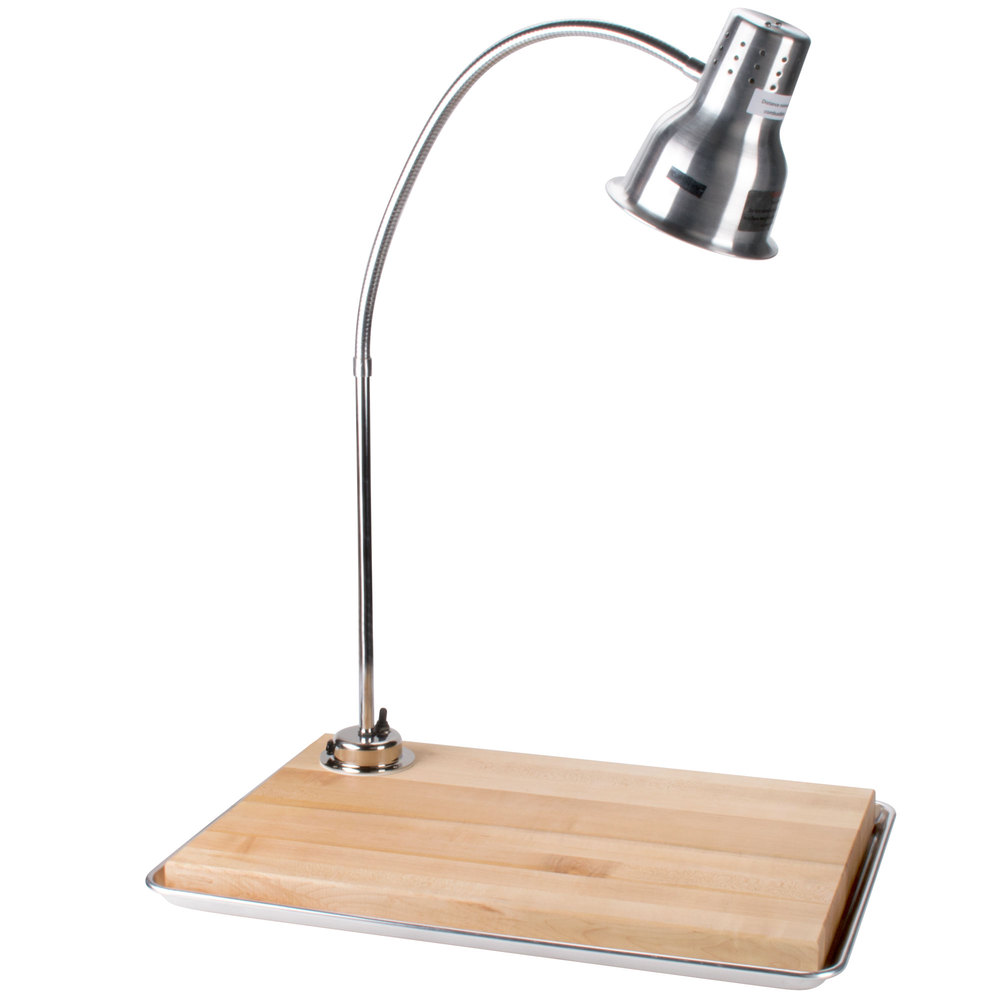 wooden carving station with a silver lamp