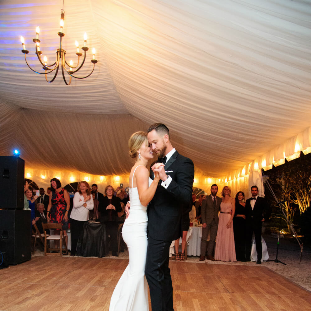 Bride and groom dancing under the chandelier