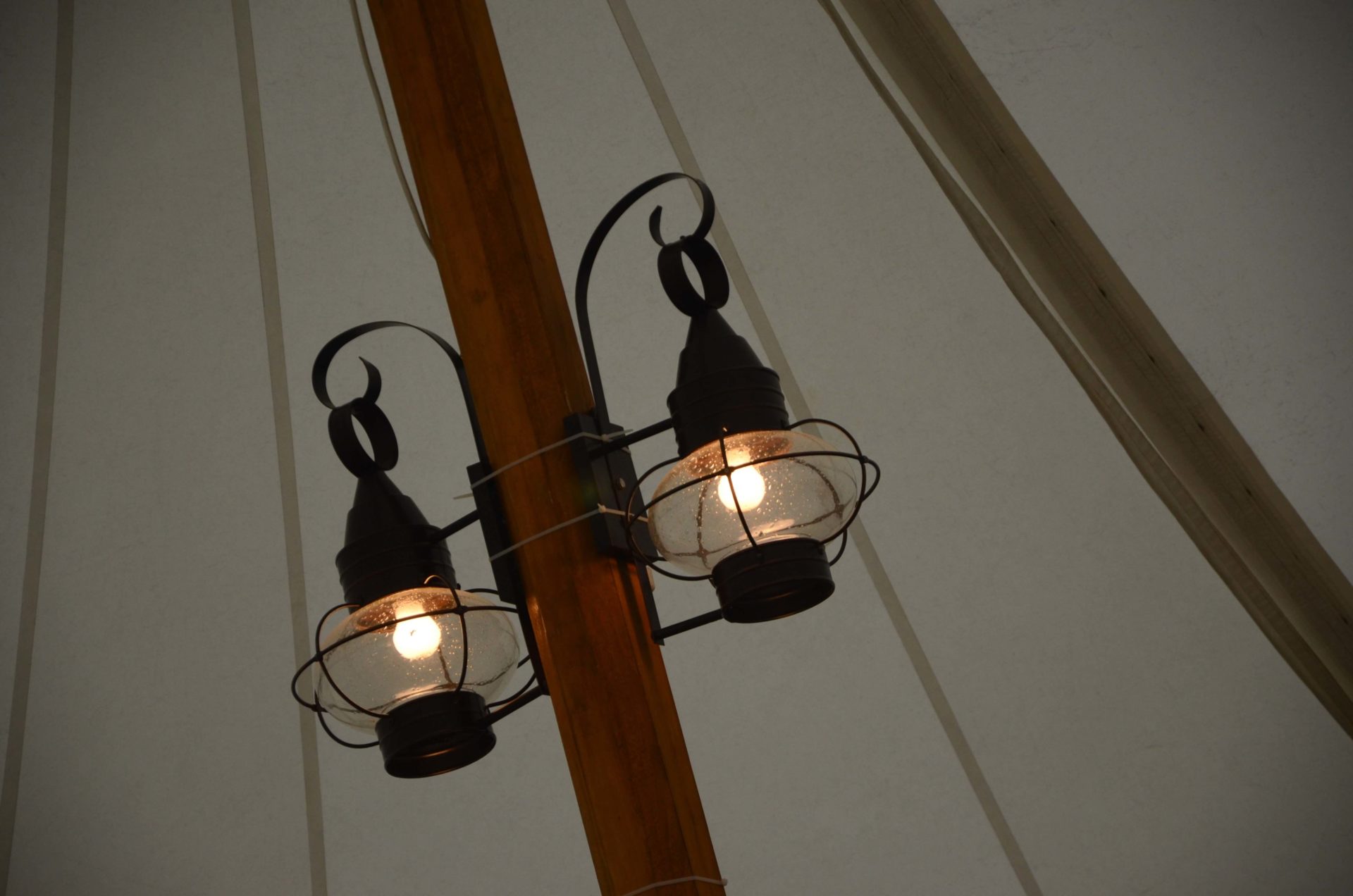 close up picture of two onion lamps on a wood beam