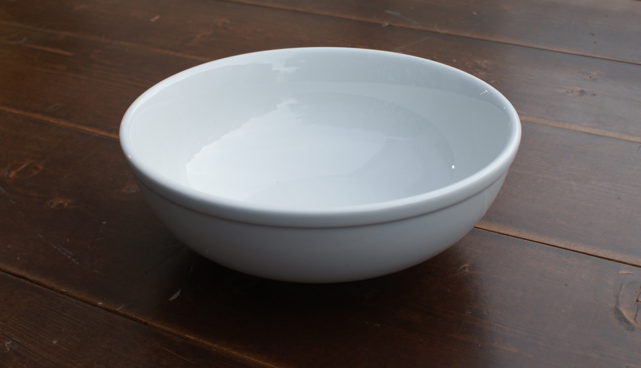 white serving bowl on a wood table