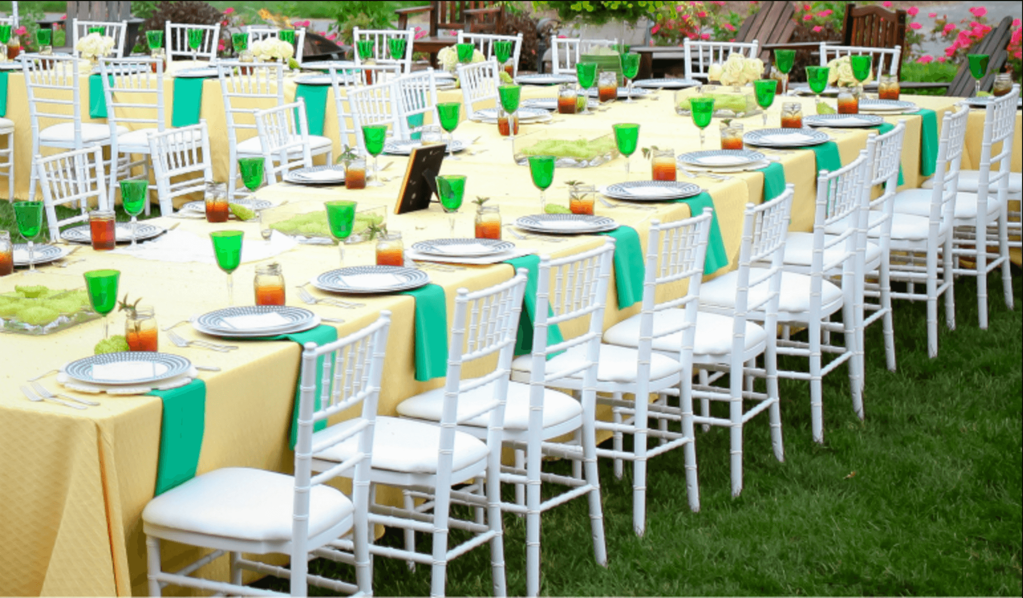 white chiavari chairs with white cushions around the table