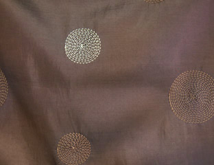 brown fabric with brown and white cirlces