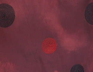 red taffeta fabric with red and purple circles