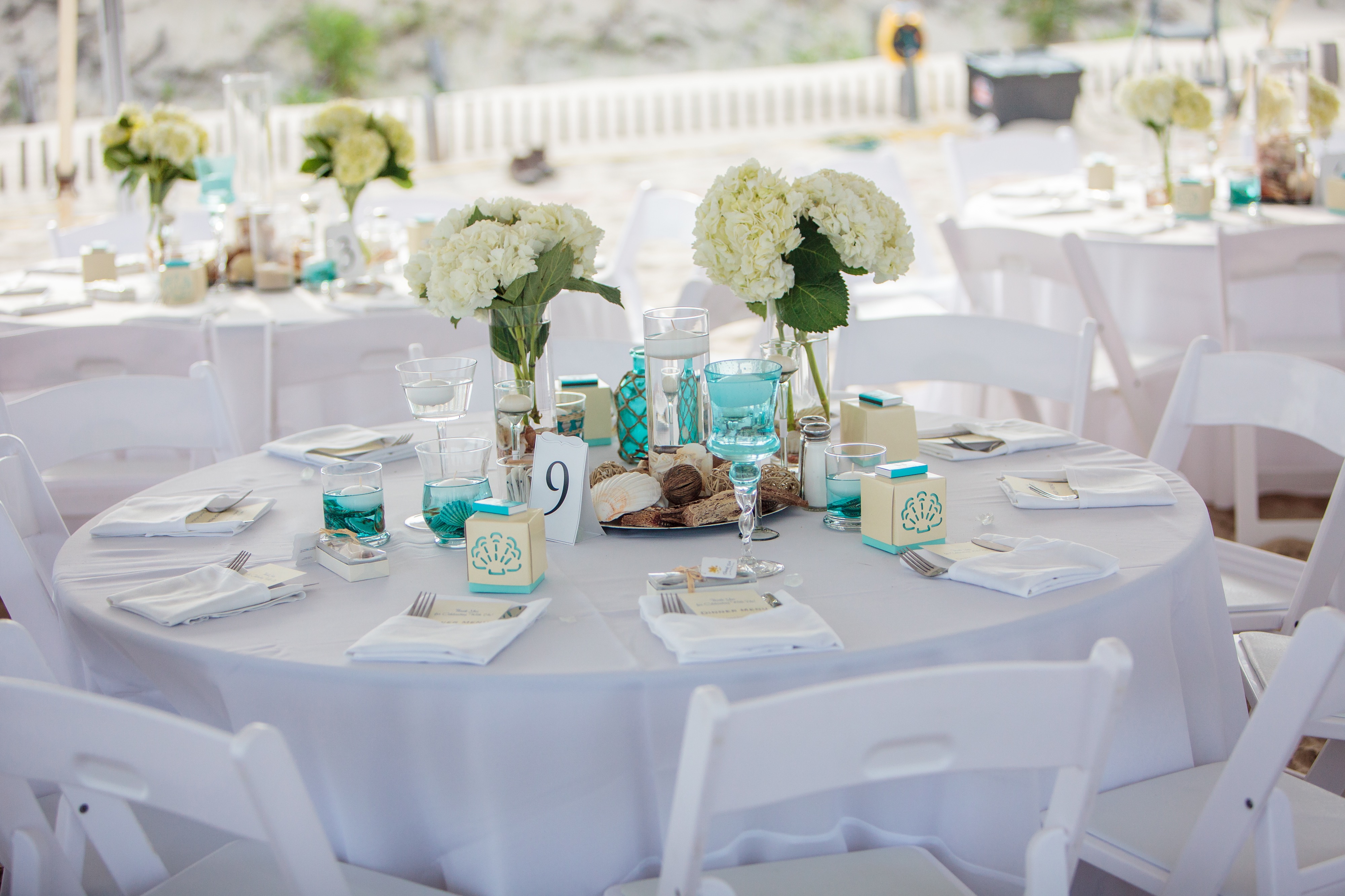 small white round table with place settings