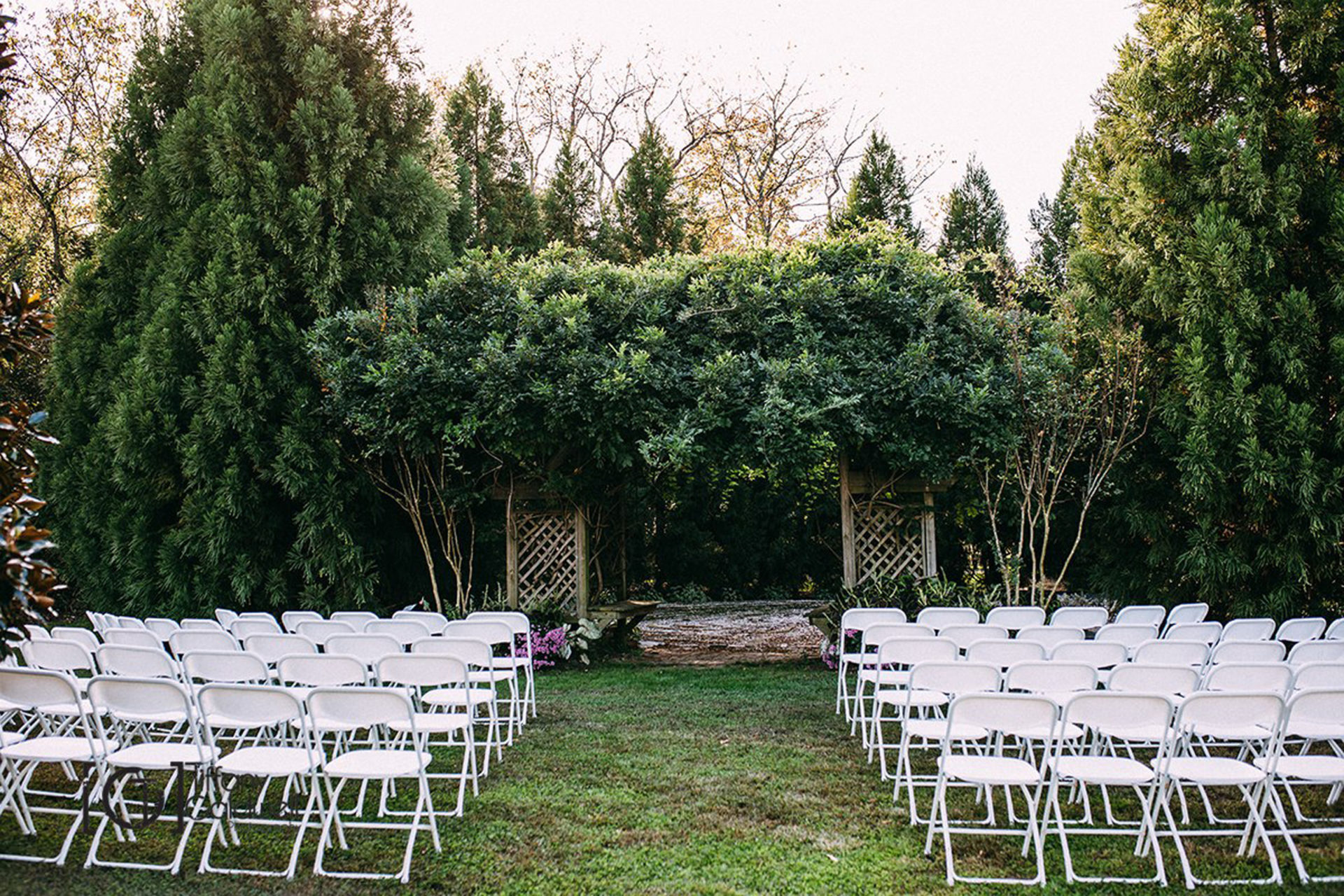 white folding chairs set up for wedding ceremony