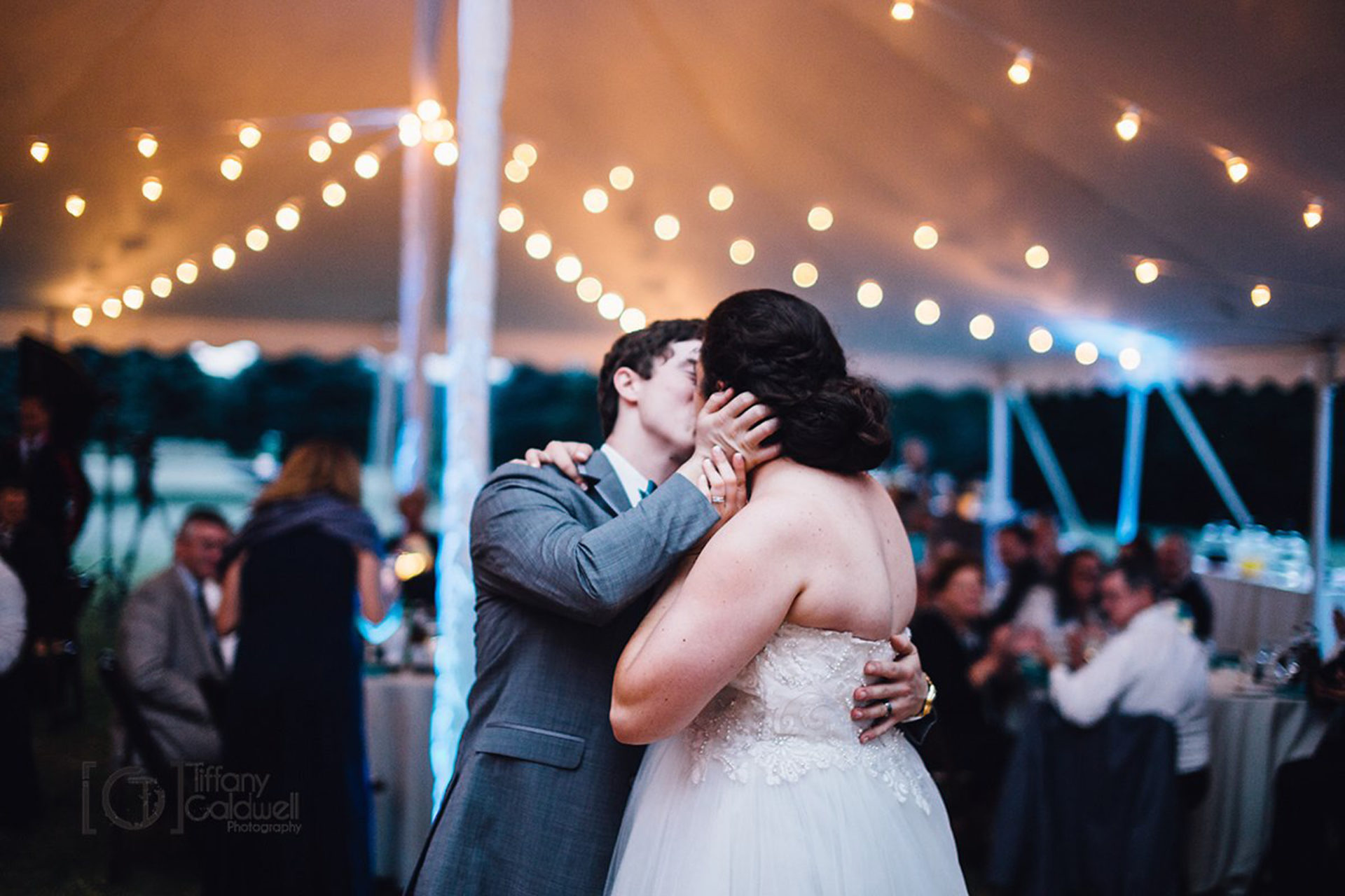 Bride and groom kissing while dancing