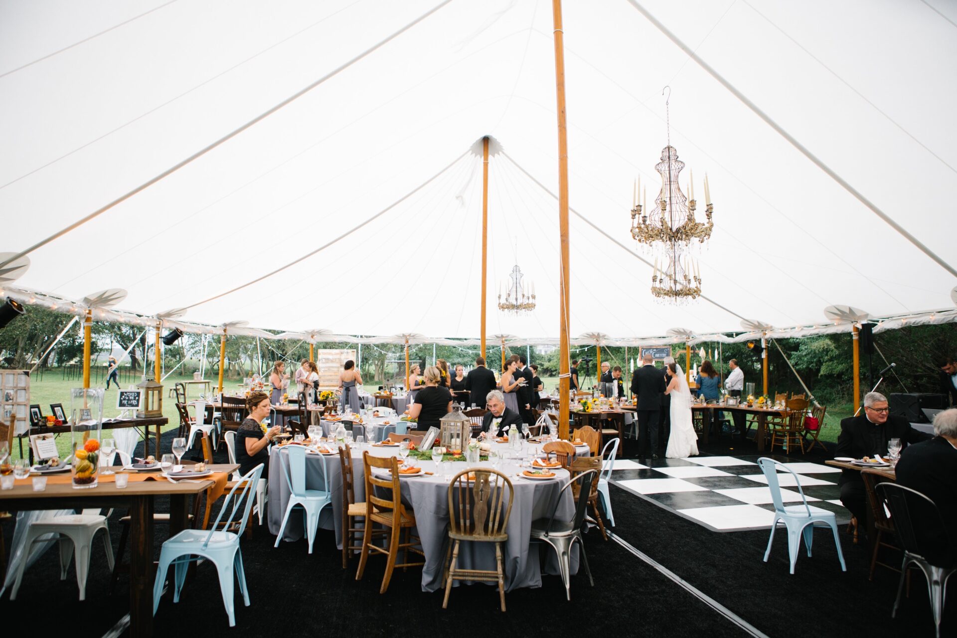 Wedding in tent with tables, guests
